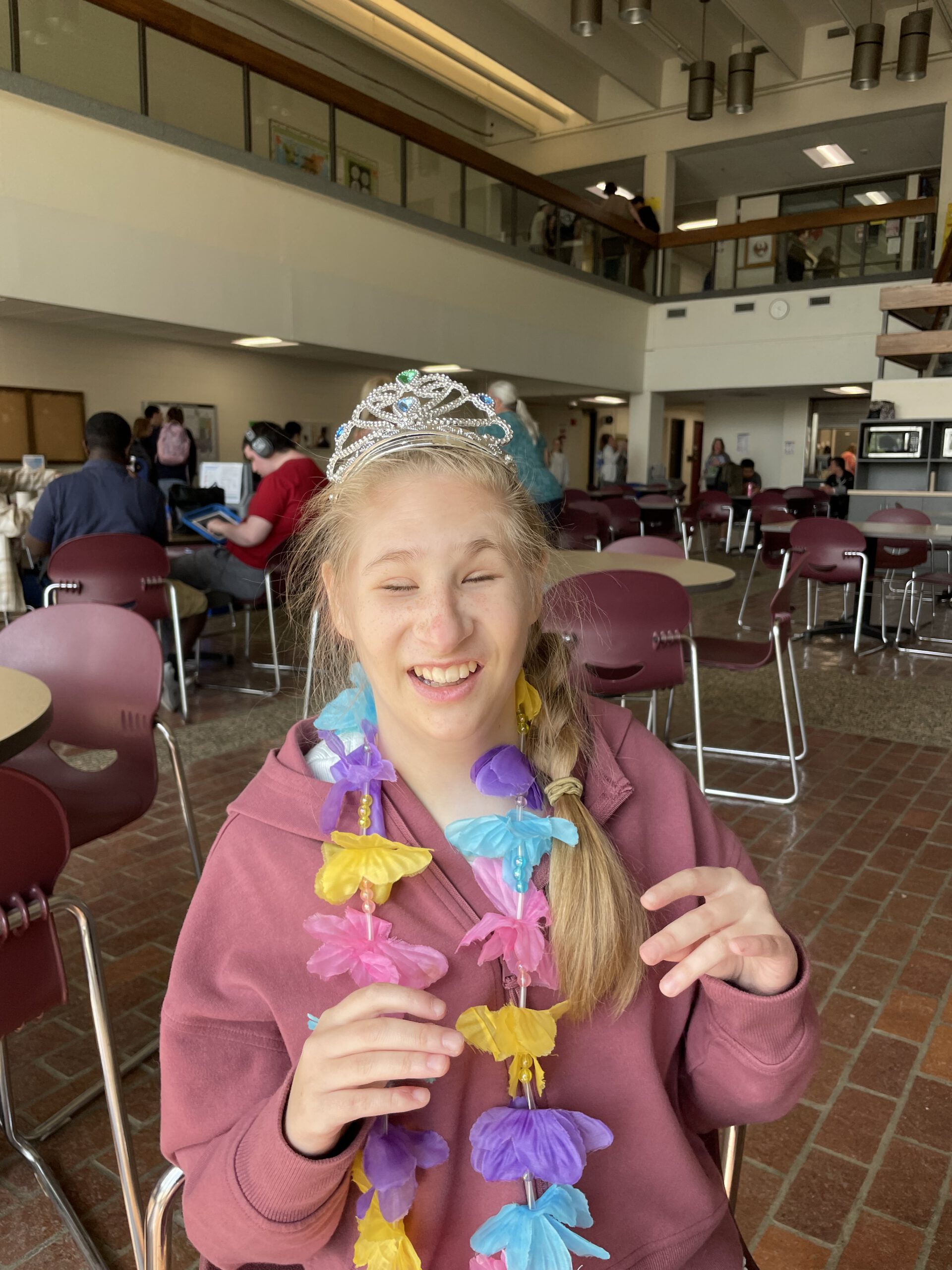 Ruby wearing a colorful lei at school