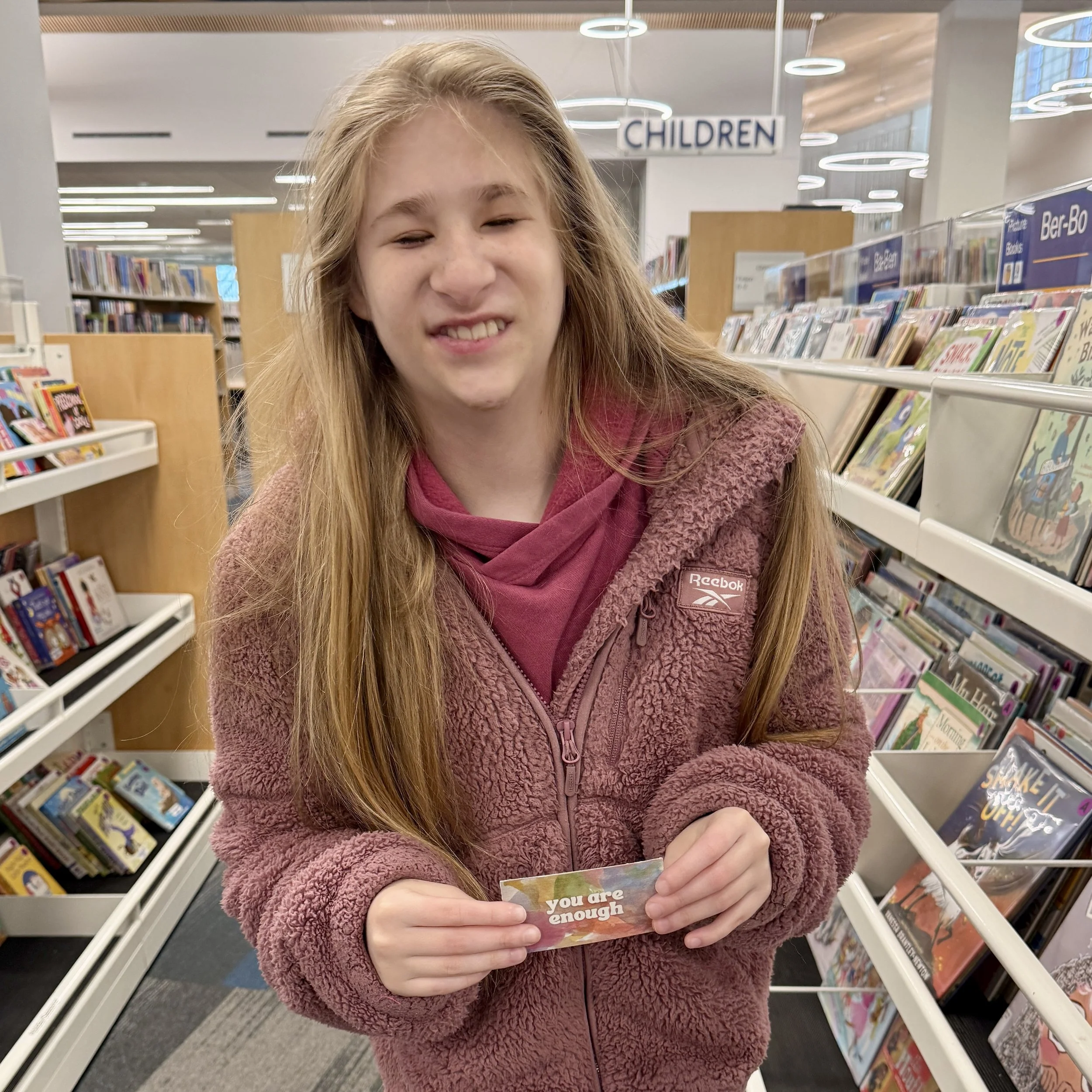 Ruby leaving kindness cards in our local library